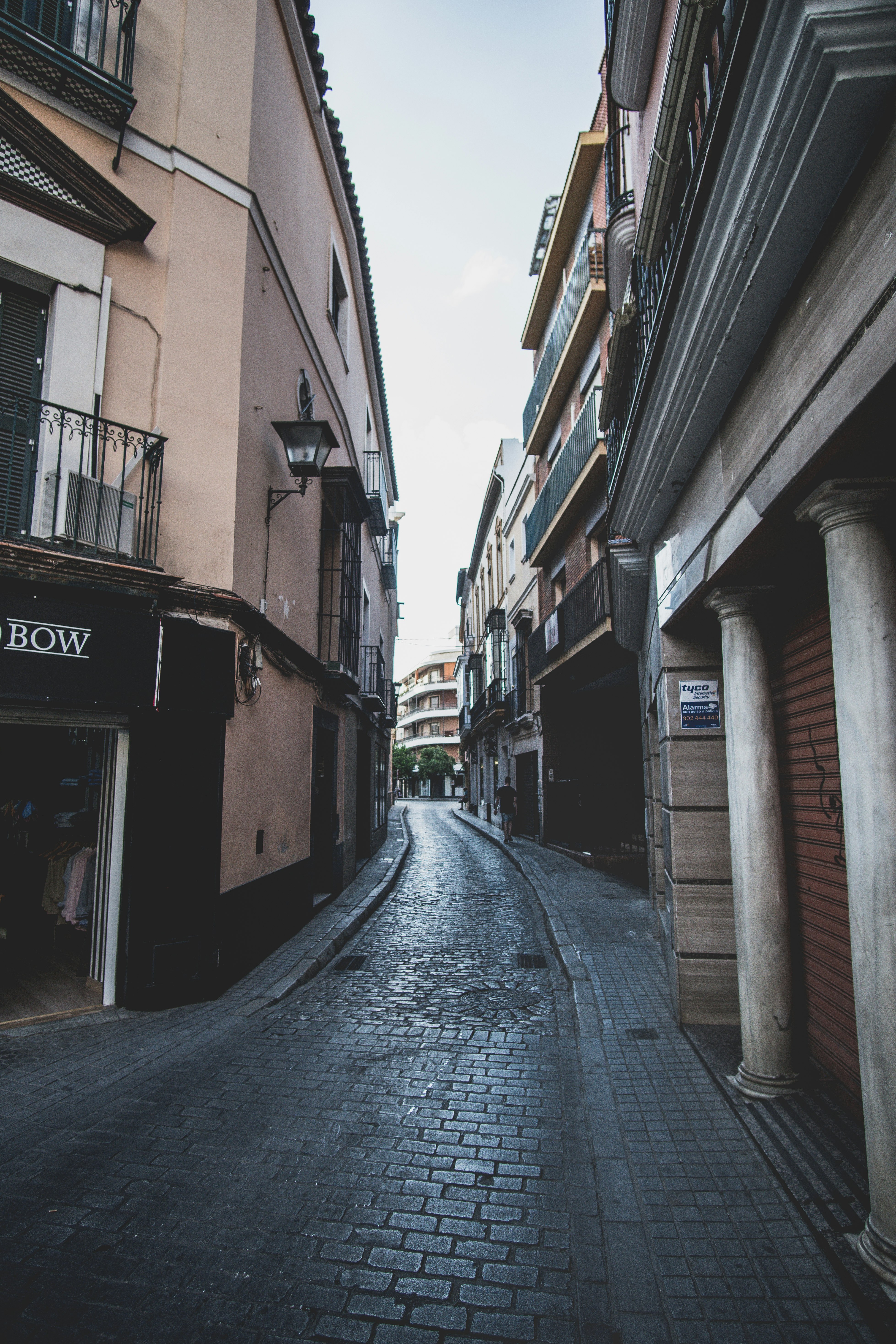 empty street in between of buildings during daytime